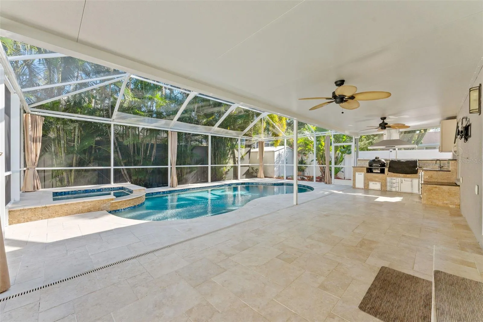 covered lanai space attached to outdoor kitchen
