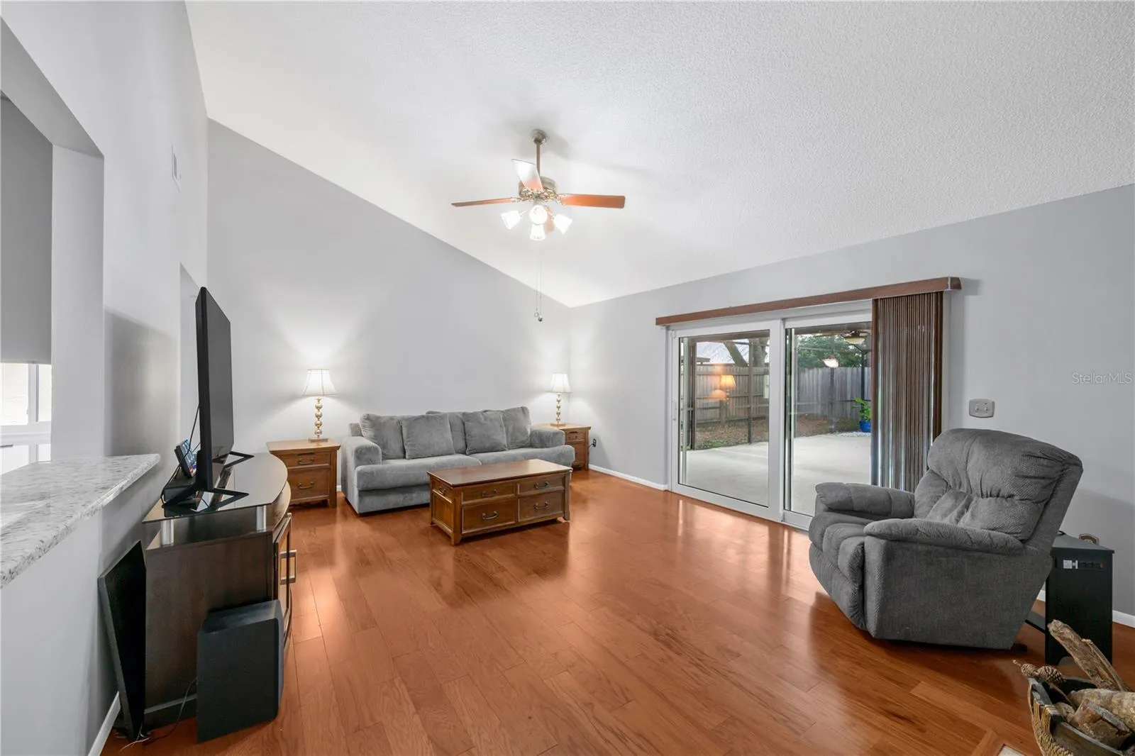 The family room has a wood burning fireplace, vaulted ceiling and easy access to the backyard pool, Spa, and patio.