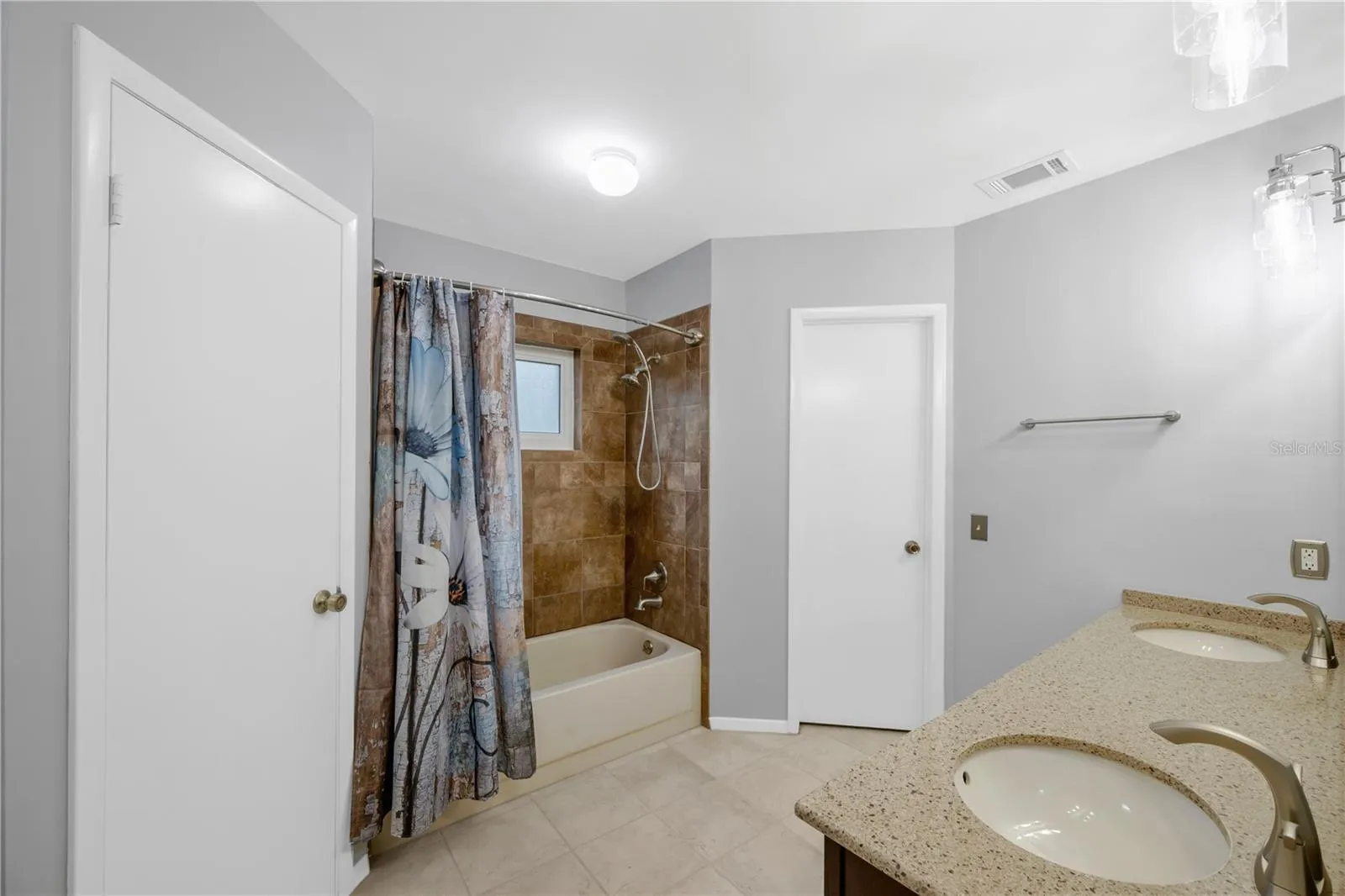 There is a tub/shower combination and 2 separate walk-in closets in this owner's bathroom on the first floor.