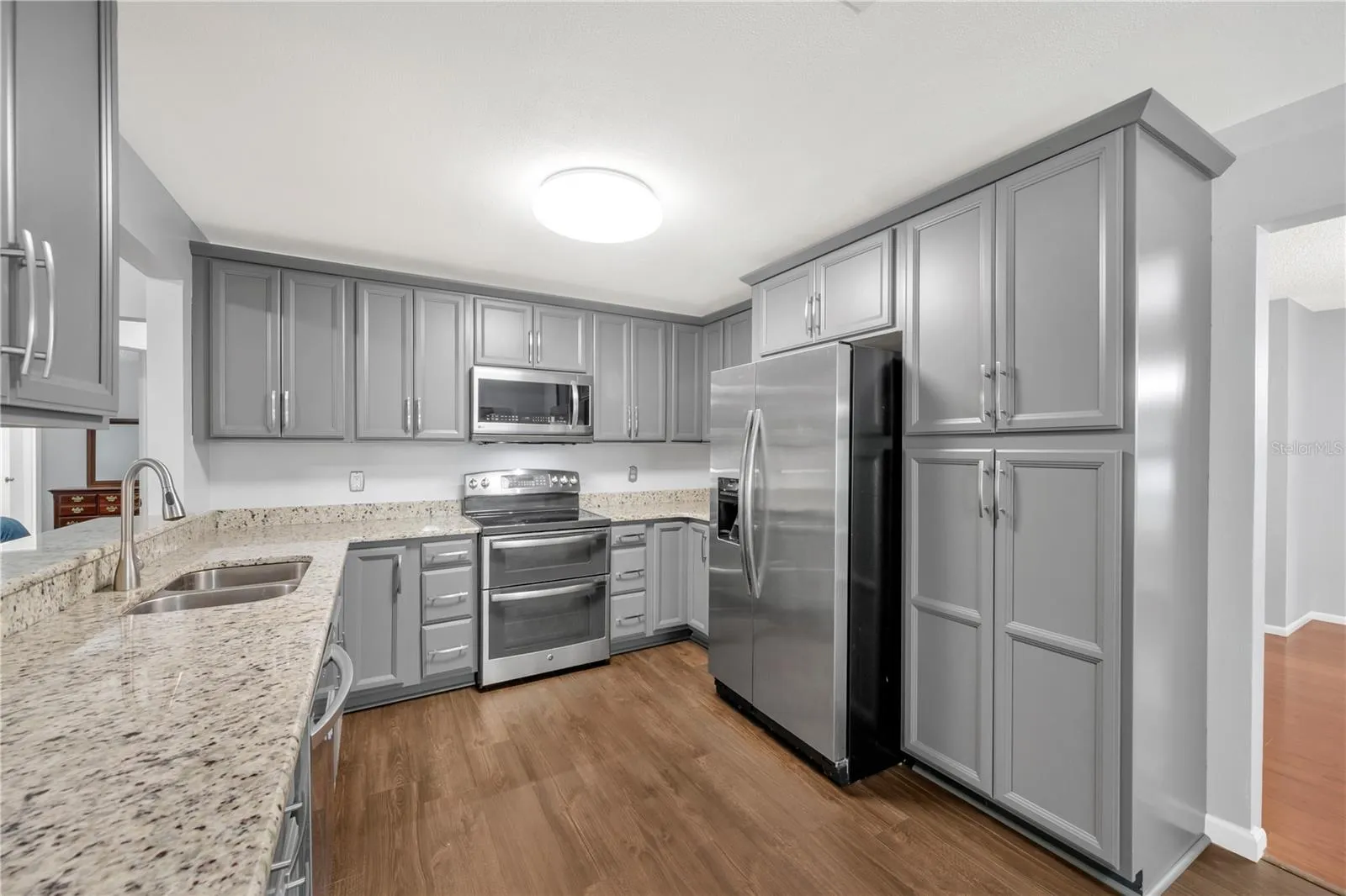 The recently remodeled kitchen features granite countertops and stainless steel appliances and flows easily into the main living areas.