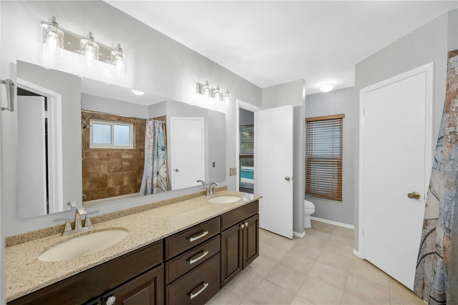 The Owner's ensuite has a large vanity with loads of storage and dual sinks on a granite counter.