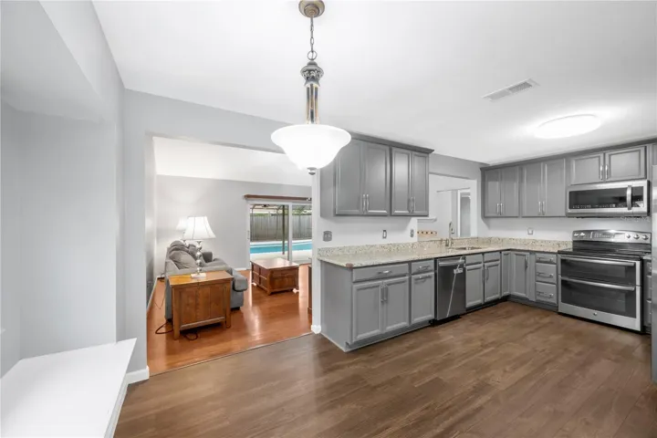 The kitchen was remodeled in 2023 with stylish cabinets, durable granite counters, stainless steel appliances and was designed with the perfect triangle work flow.