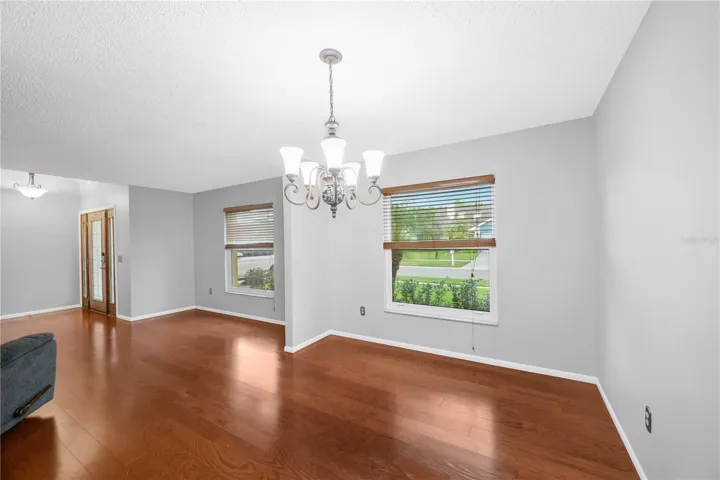 Additional living areas include a living room and a dining room next to the kitchen.