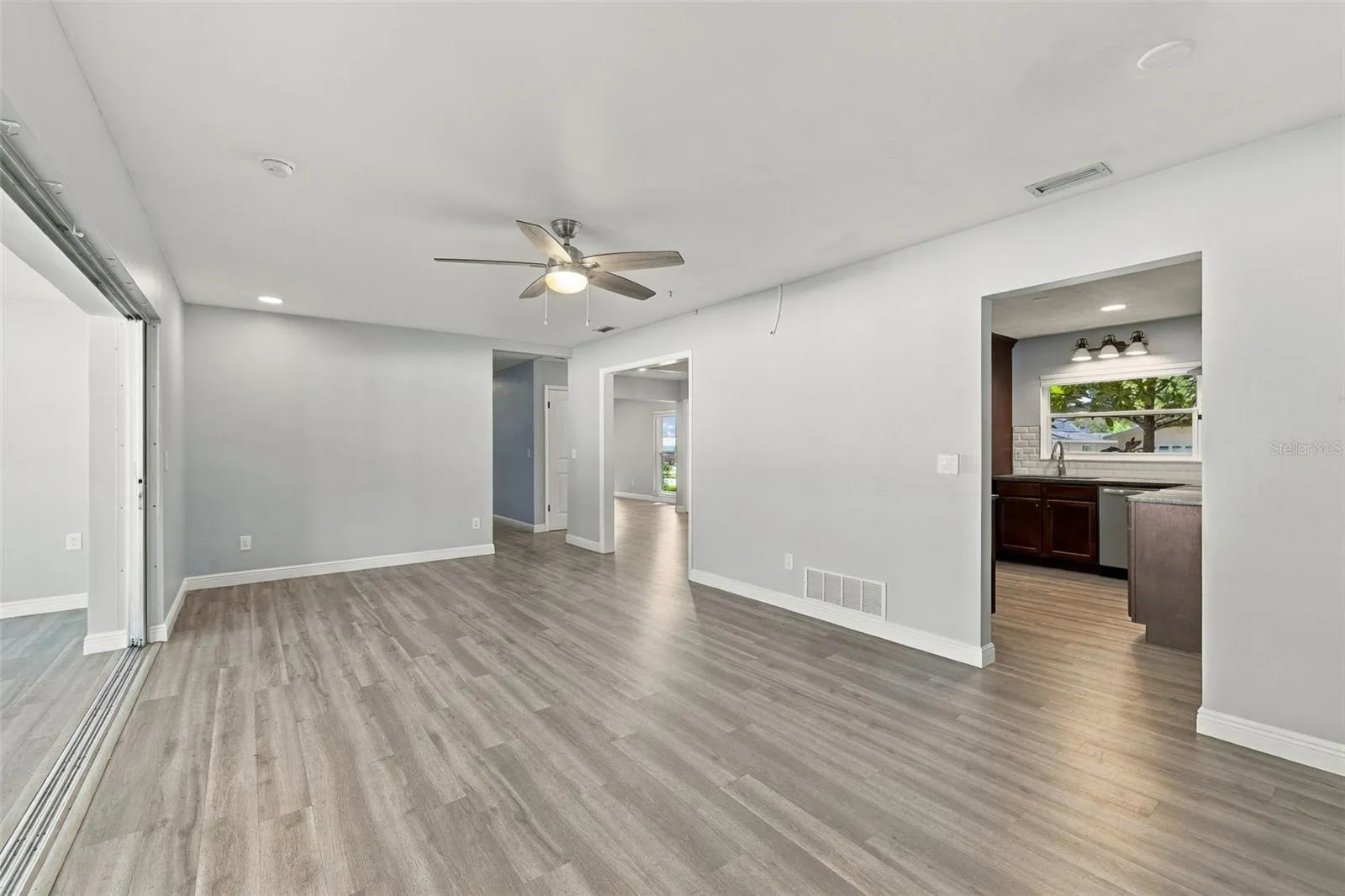 The hall on the far side leads to two additional bedrooms that share a bathroom. The split floor plan is great for creating separation and privacy for the bedrooms.