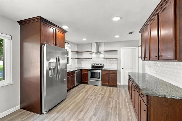 Granite counters, stainless steel appliances and a vented hood above the range give this kitchen a contemporary look and feel with excellent functionality.