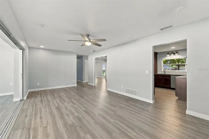 The hall on the far side leads to two additional bedrooms that share a bathroom. The split floor plan is great for creating separation and privacy for the bedrooms.