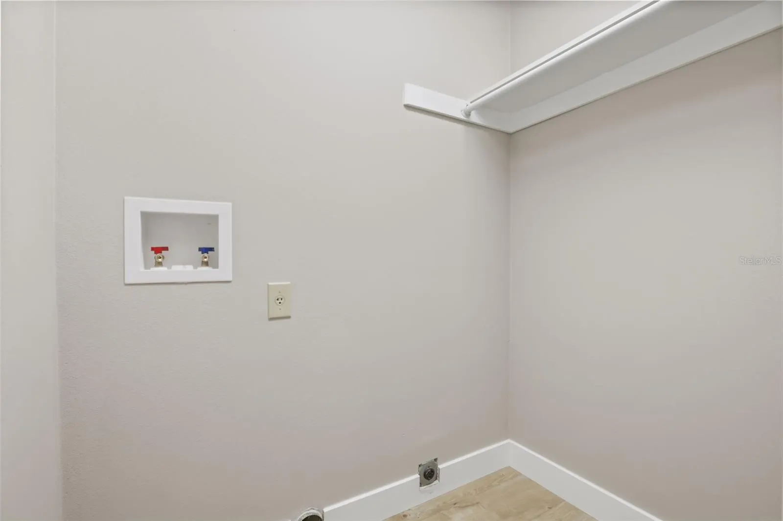 Spacious Indoor Laundry with Closet Hanging Rod