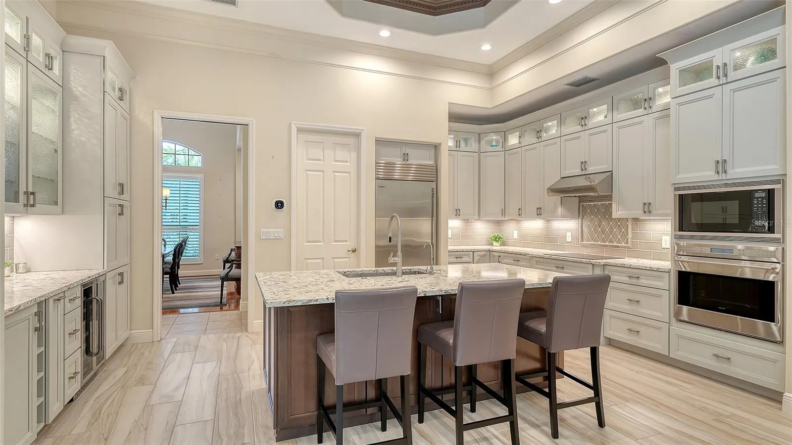 Large chef's kitchen features Subzero refrigerator, Wolf cooktop, oven and microwave and Bosch dishwasher