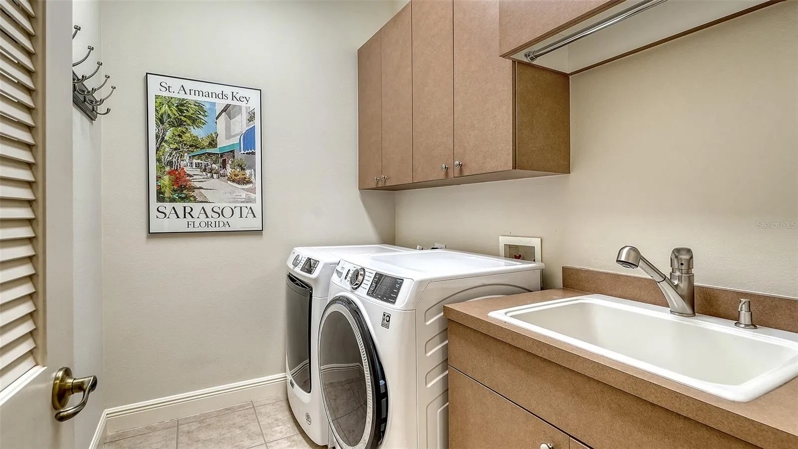 Spacious laundry room with newer washer and dryer