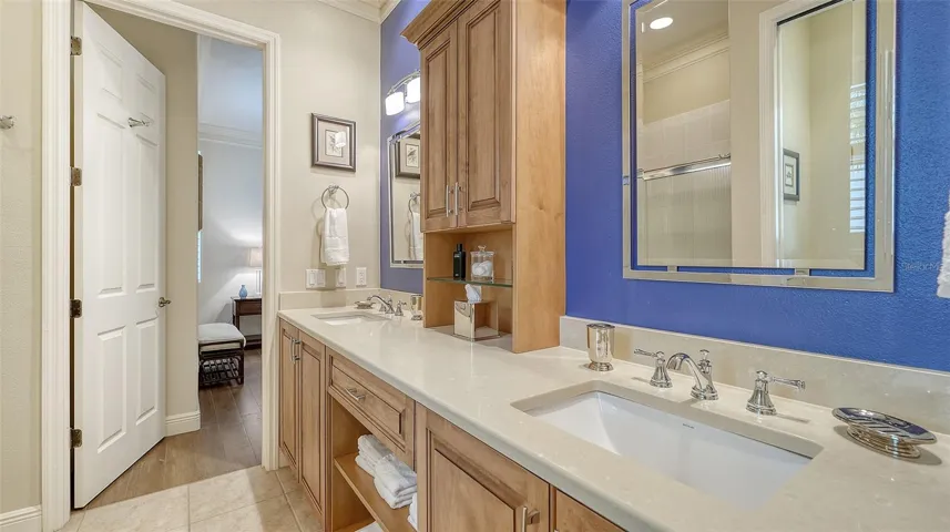 Large guest bathroom with double vanities and custom cabinetry