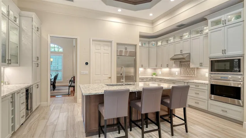 Large chef's kitchen features Subzero refrigerator, Wolf cooktop, oven and microwave and Bosch dishwasher
