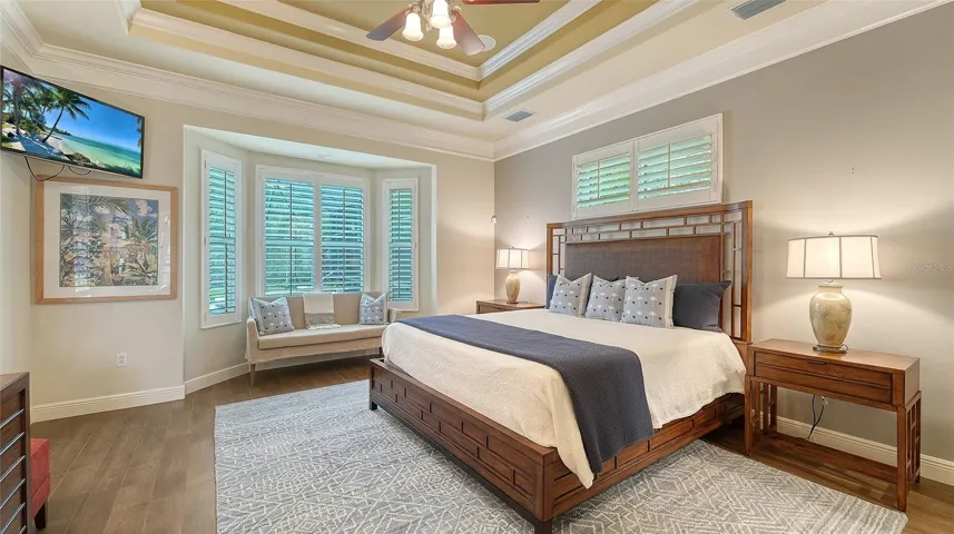 Master suite with beautiful bay window and newer wood look tile flooring