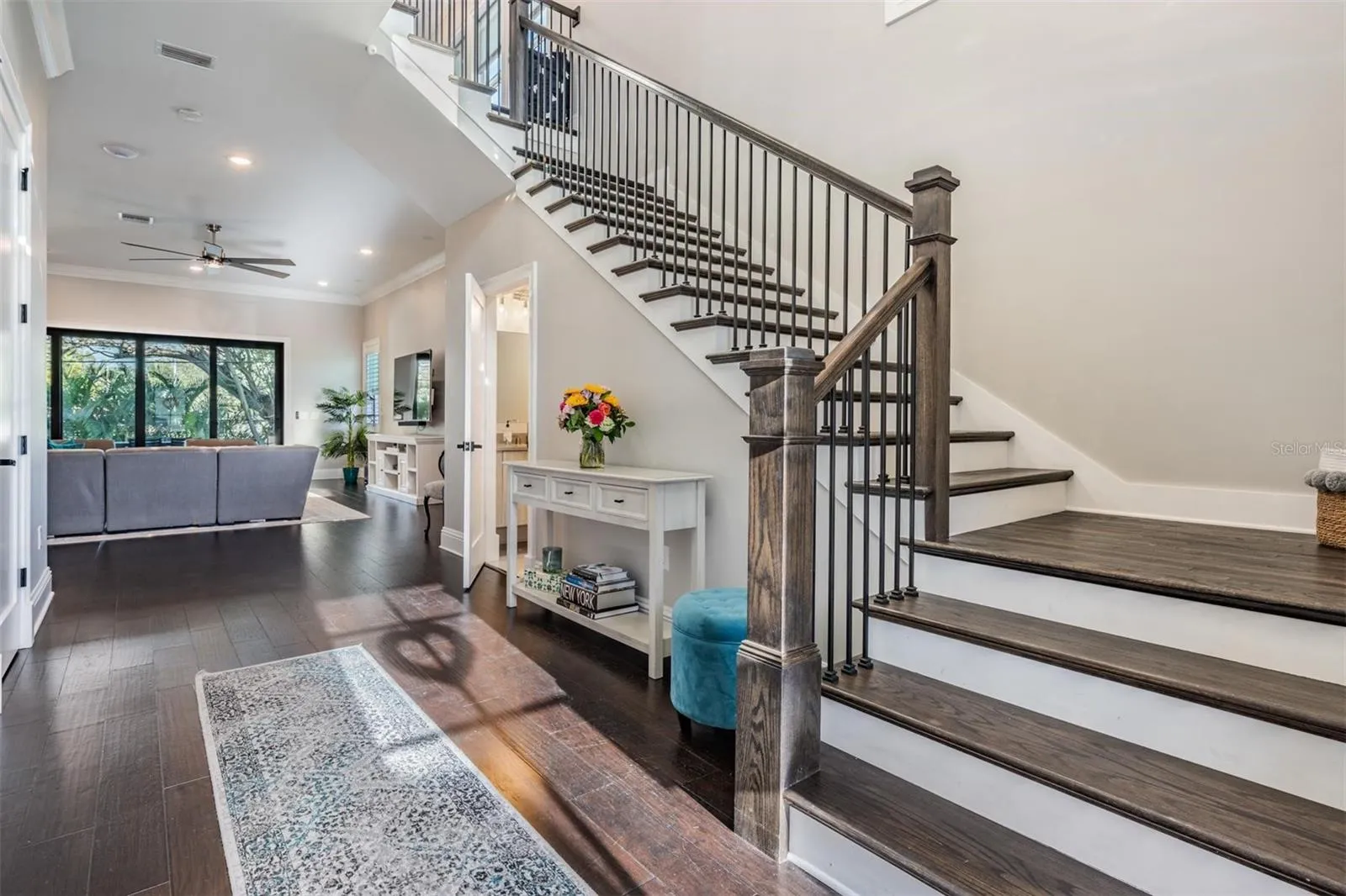 An inviting foyer with hardwood staircase to upstairs bonus space.