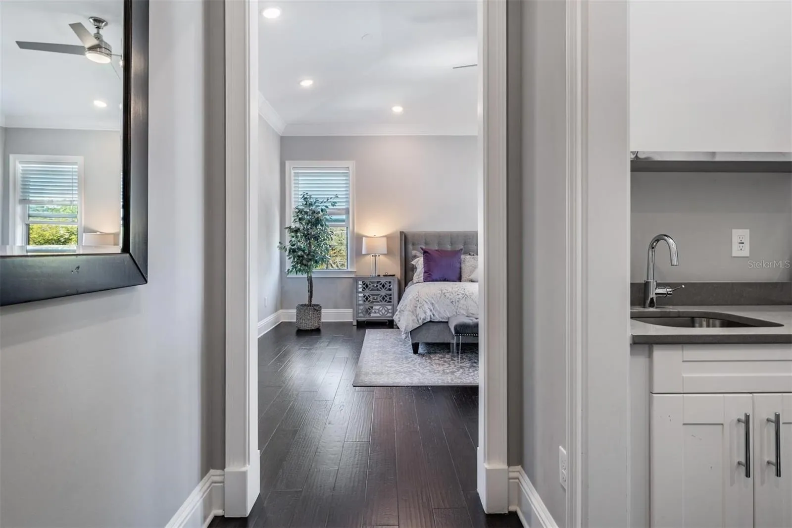 As you enter the primary bedroom, a wet bar and coffee station is on the right.