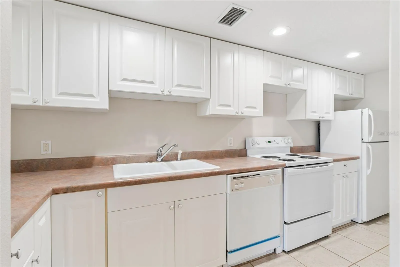 Basement kitchenette serving the full lower-level living space.