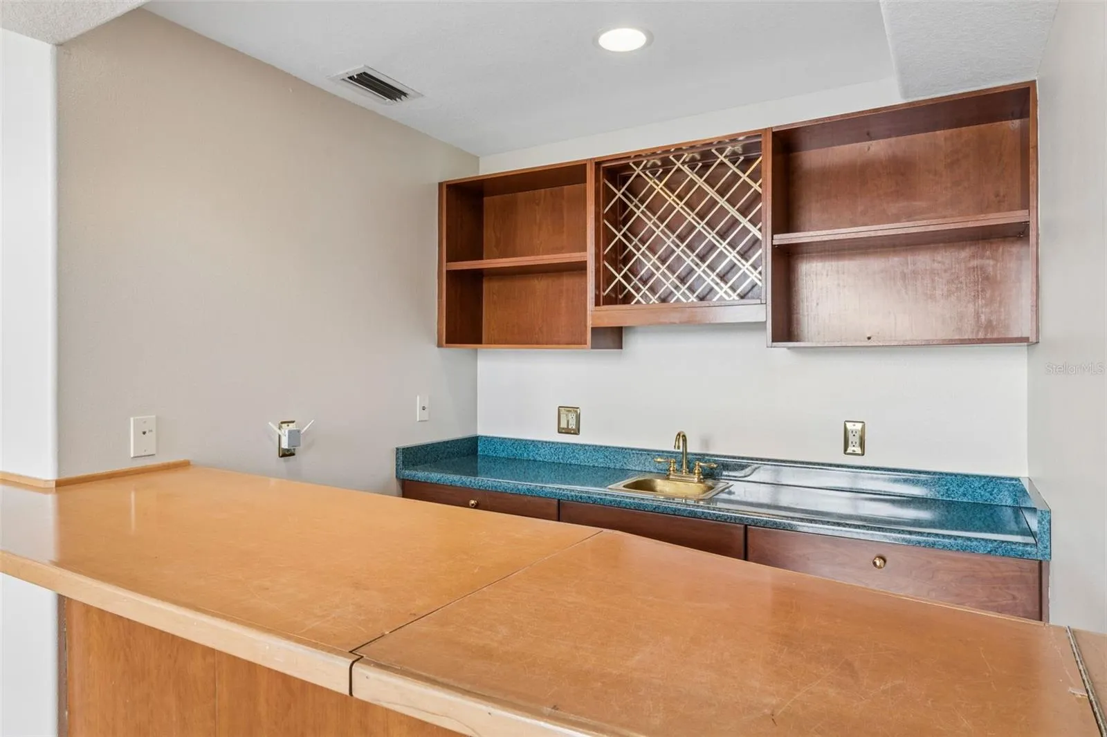 Built-in wet bar connected to the sunken great room, perfect for entertaining.