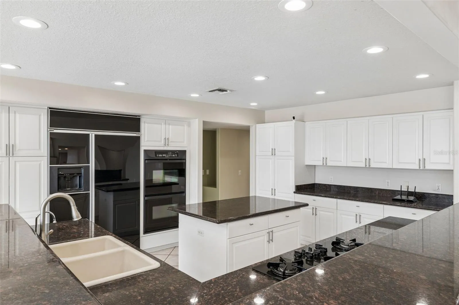 Spacious kitchen with abundant cabinetry, center island, and generous prep space for everyday living and entertaining.