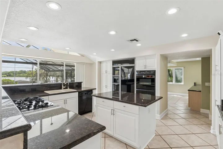 Spacious kitchen with lake views, center island, and seamless flow into the dining room.