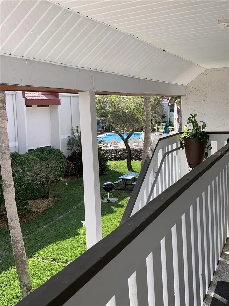 View from front porch with pool only 25 steps to the pool and 3 minutes to the beach.