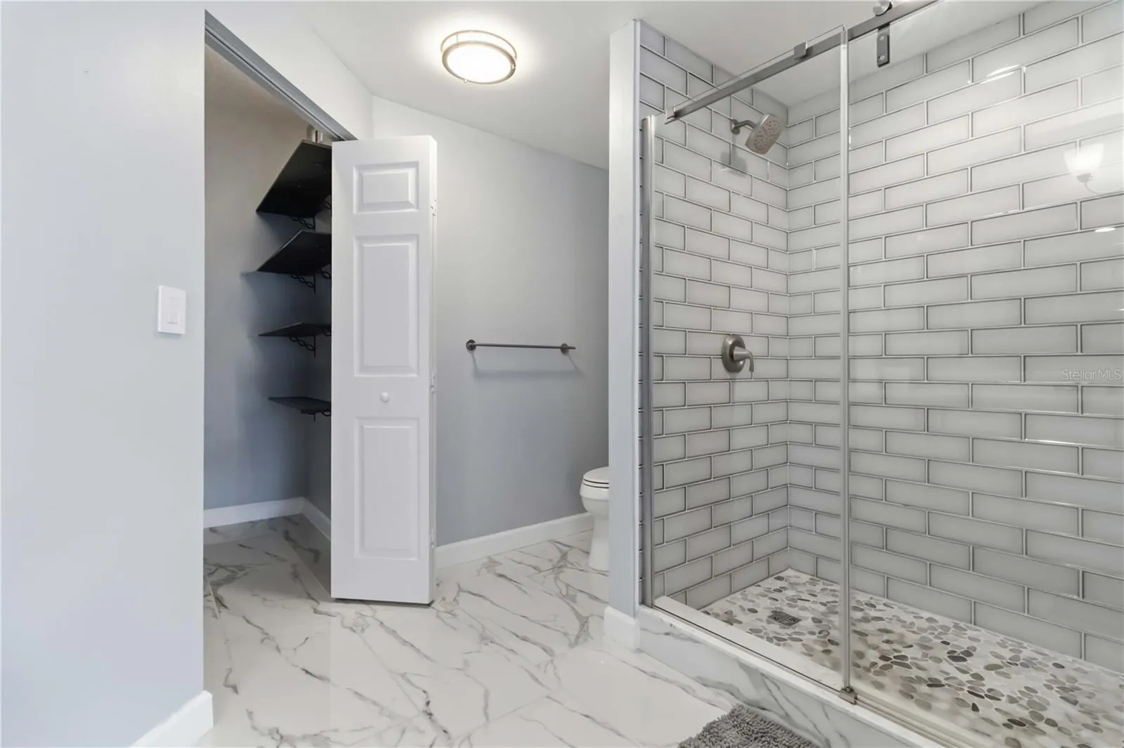 Redesigned primary bath features impressive oversized walk-in shower.