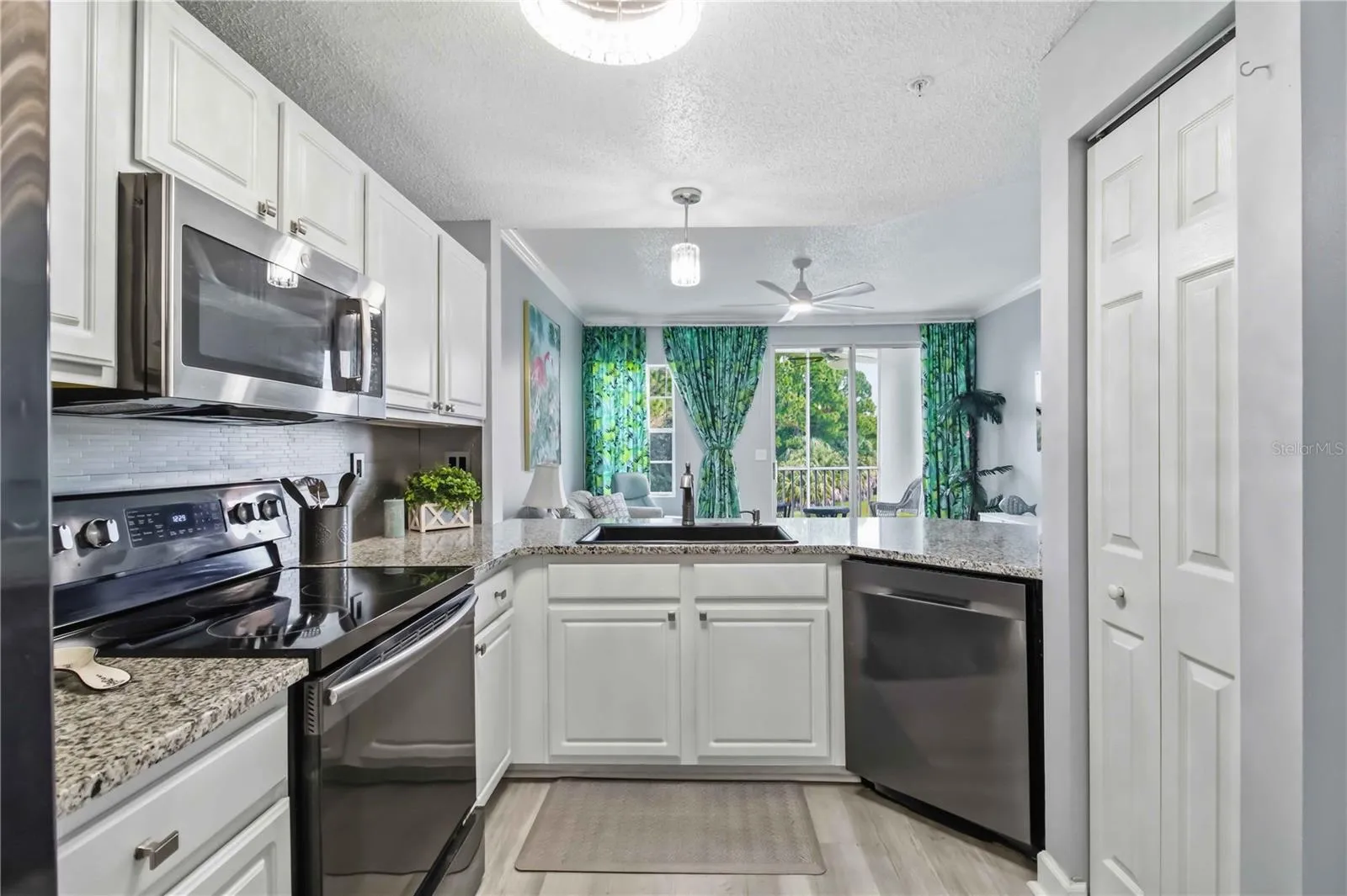 The updated kitchen offers granite countertops, abundant cabinetry, generous prep space and a center island.