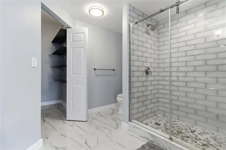 Redesigned primary bath features impressive oversized walk-in shower.