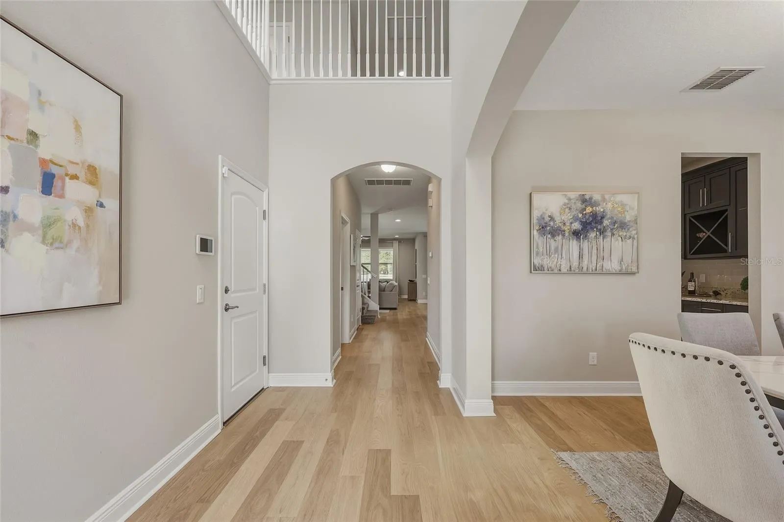 Two Story Foyer with Formal Dining room and Butler's Pantry leading to the Kitchen