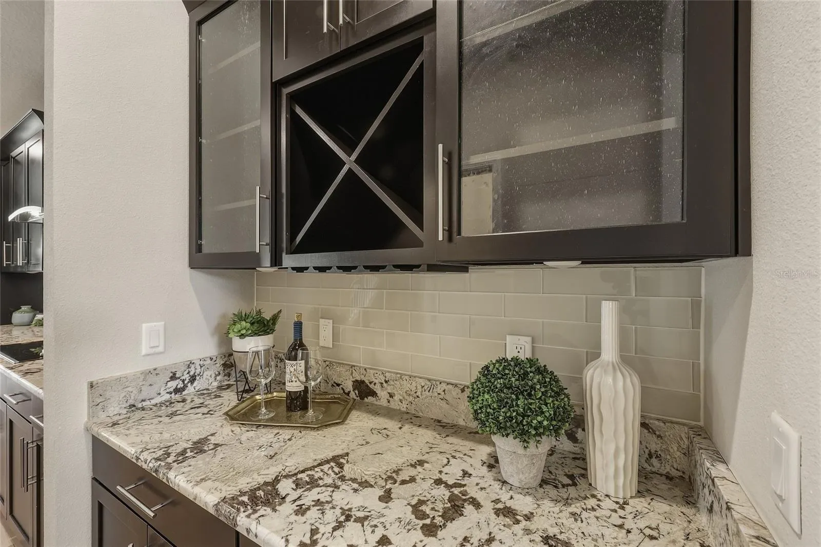 Butler's pantry with built-in wine storage and glass-front cabinetry