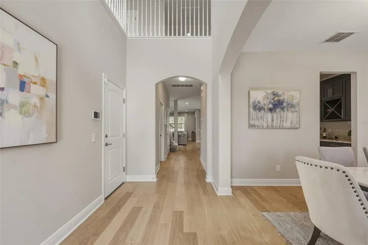 Two Story Foyer with Formal Dining room and Butler's Pantry leading to the Kitchen