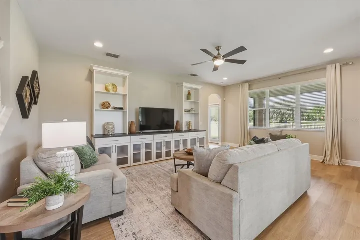 Living room featuring built-in cabinetry and shelving