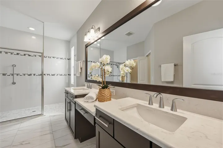 Private first floor en-suite bath with dual vanities and spacious walk-in shower