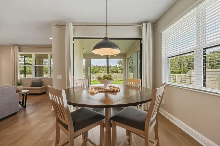 Light-filled eat-in kitchen with oversized window and sliding glass doors leading to the back patio