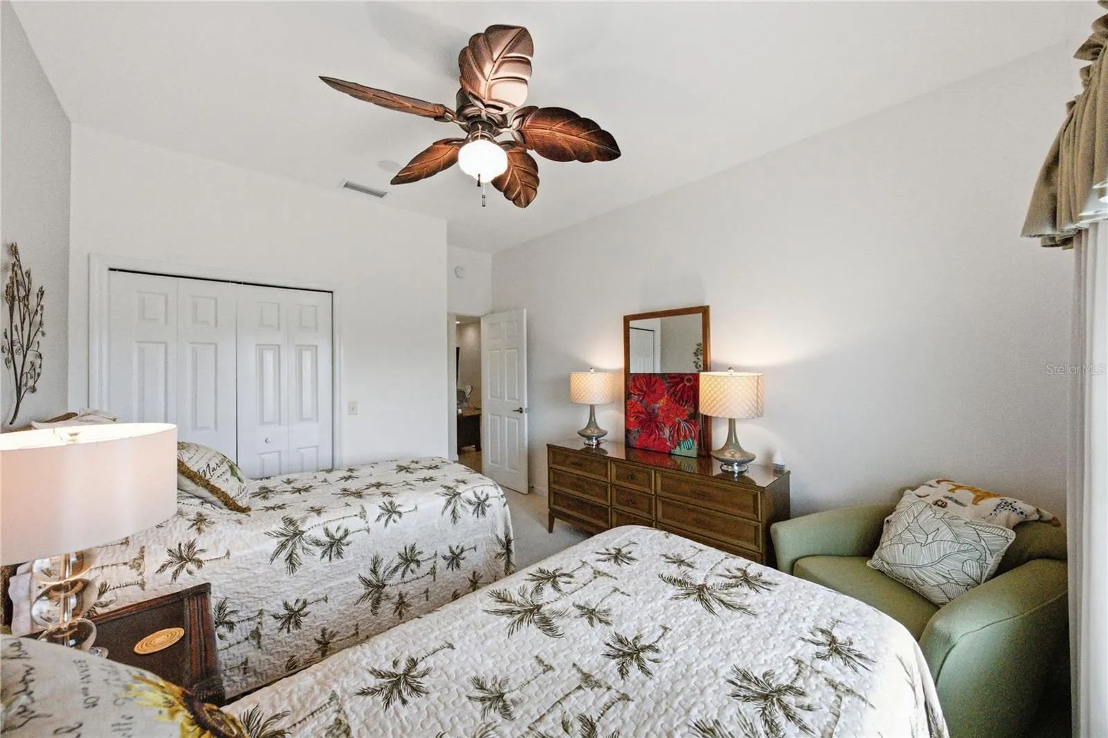 The guest bedroom has a ceiling fan with light and a reach-in closet.