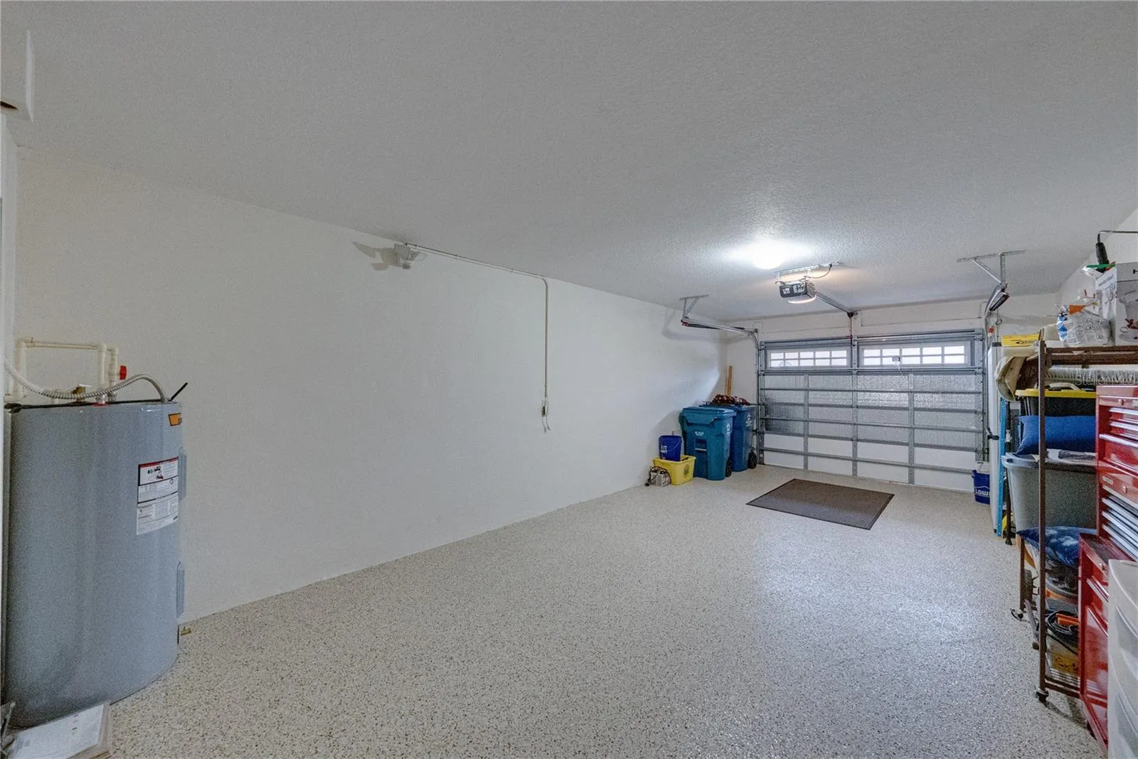 The attached garage has an opener and windows in the garage door.