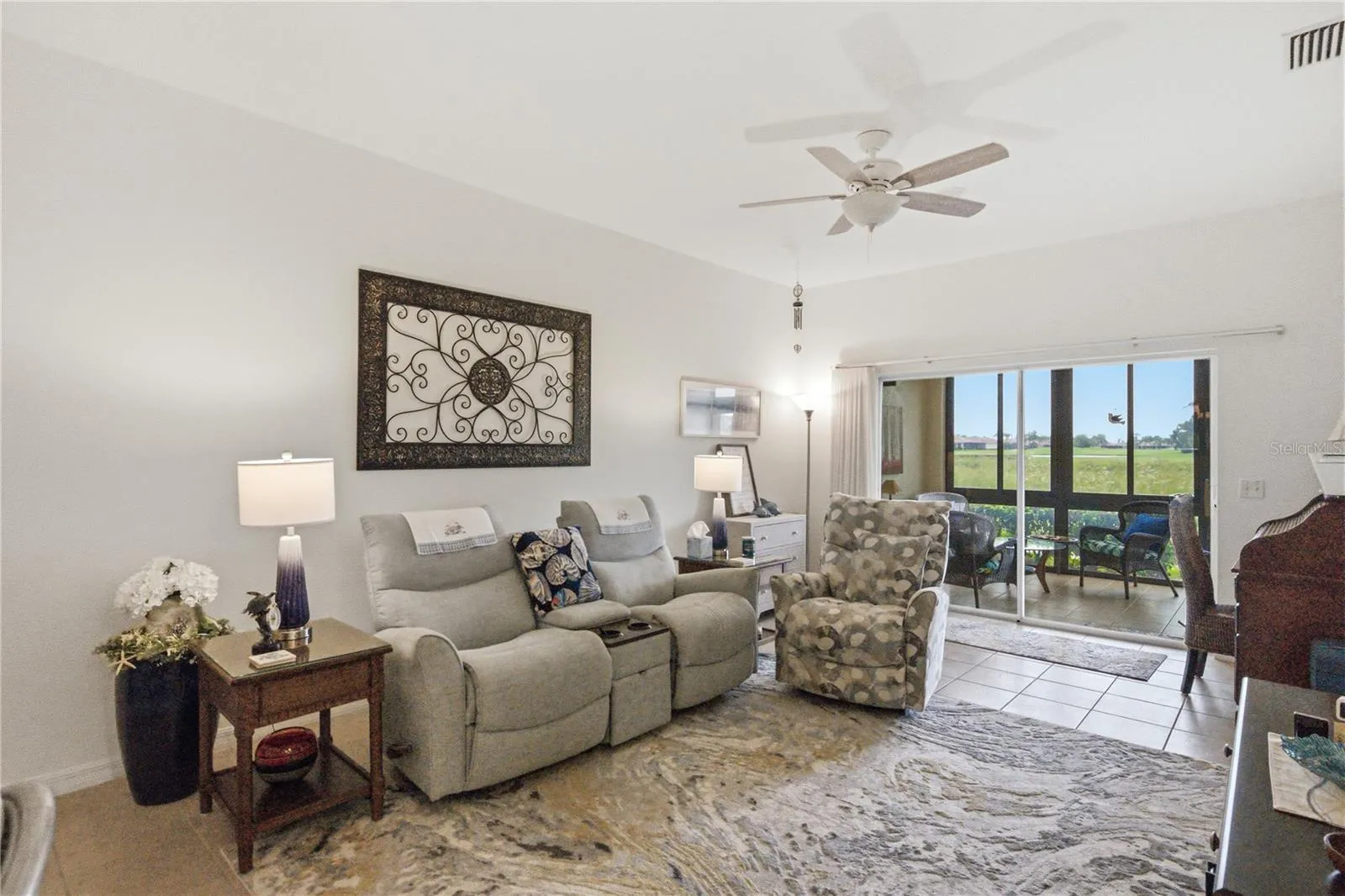 The living room has a double slider to the enclosed lanai.