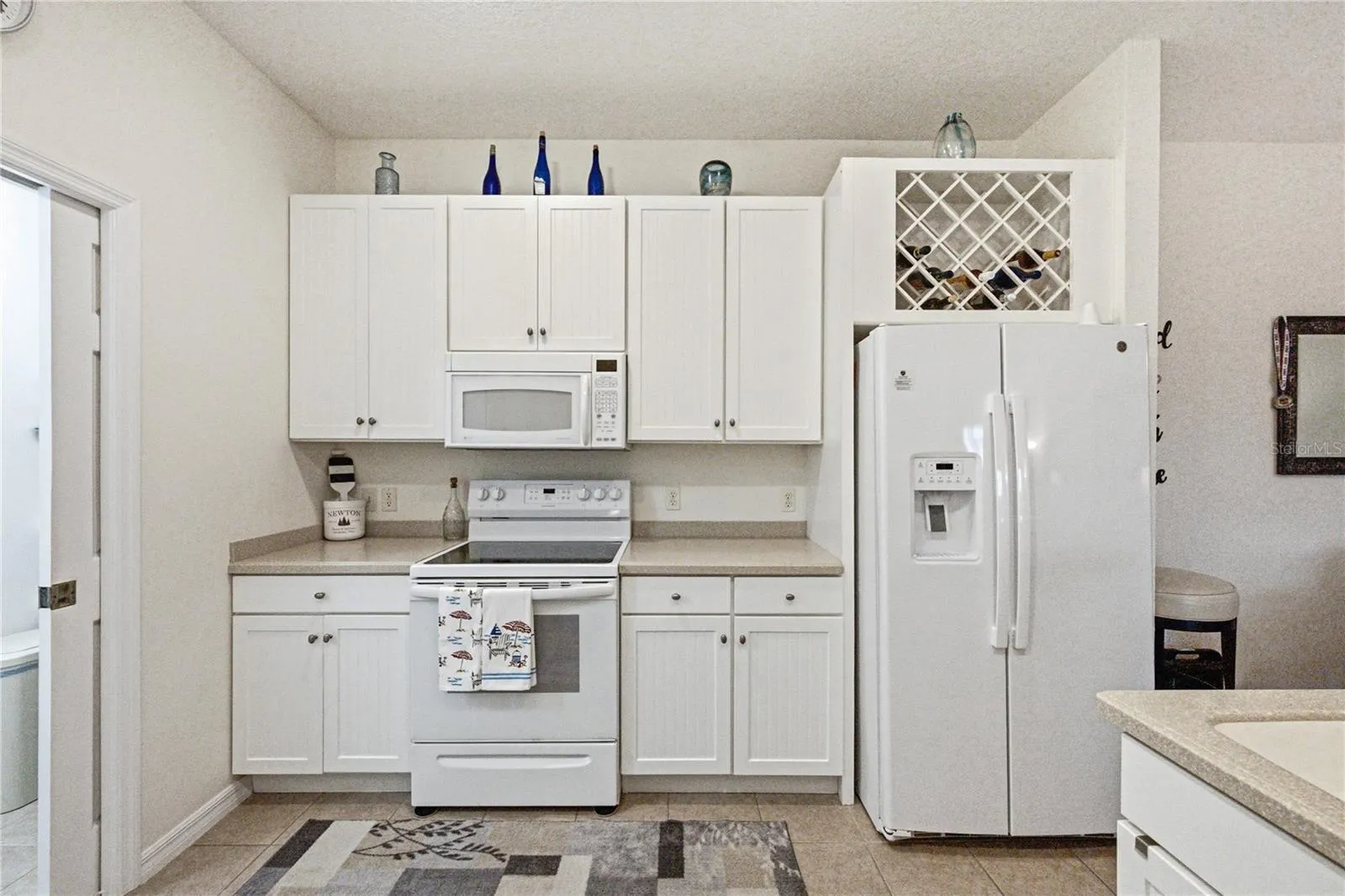 The cabinetry includes 42" uppers and a wine rack over the refrigerator.