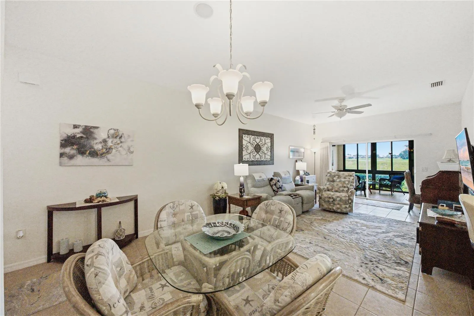 The living room has a custom ceiling fan with light, ceramic tile flooring, and window treatments.