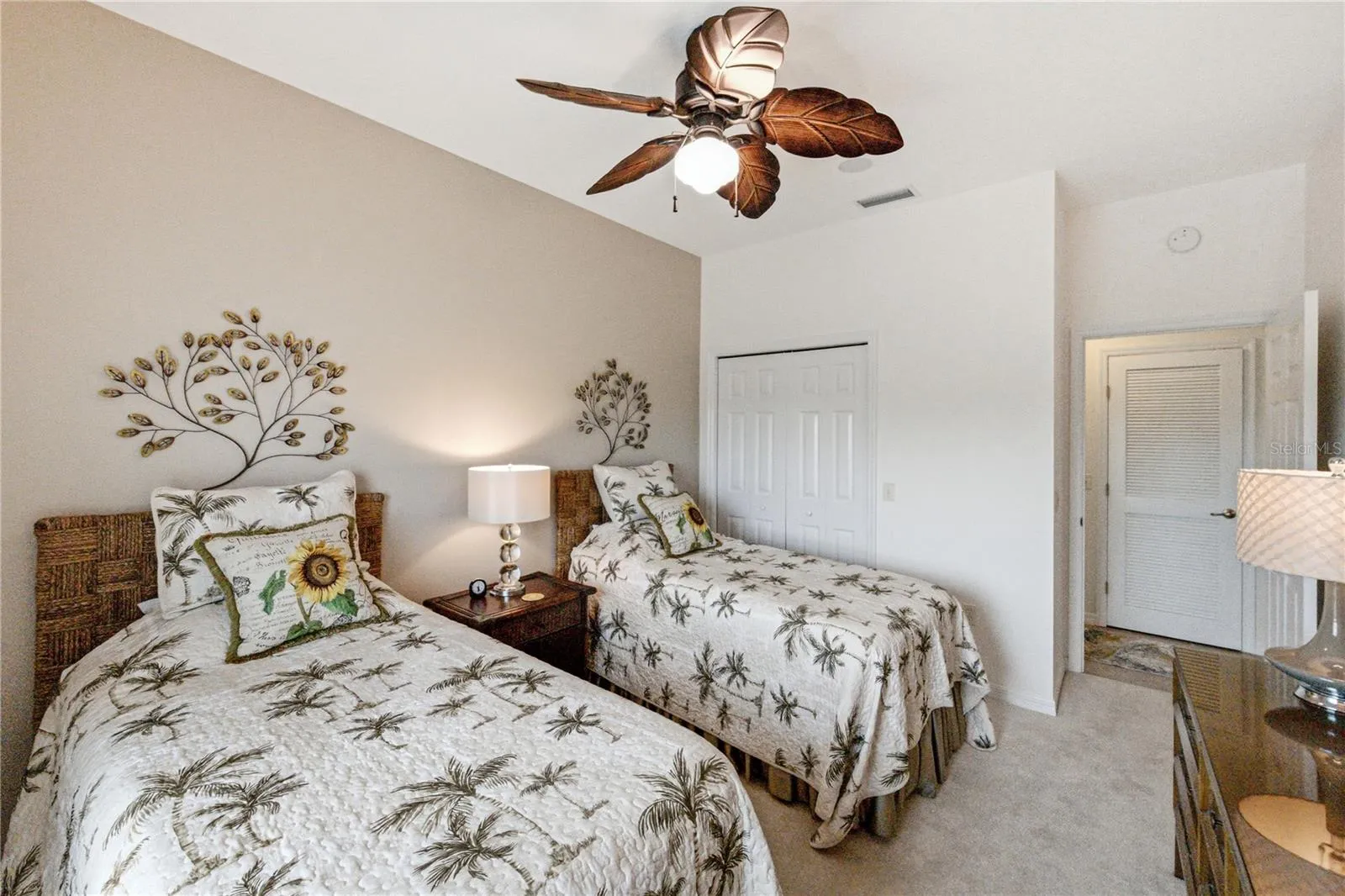 The guest bedroom has a designer ceiling fan with light, reach-in closet, and quality carpeting.