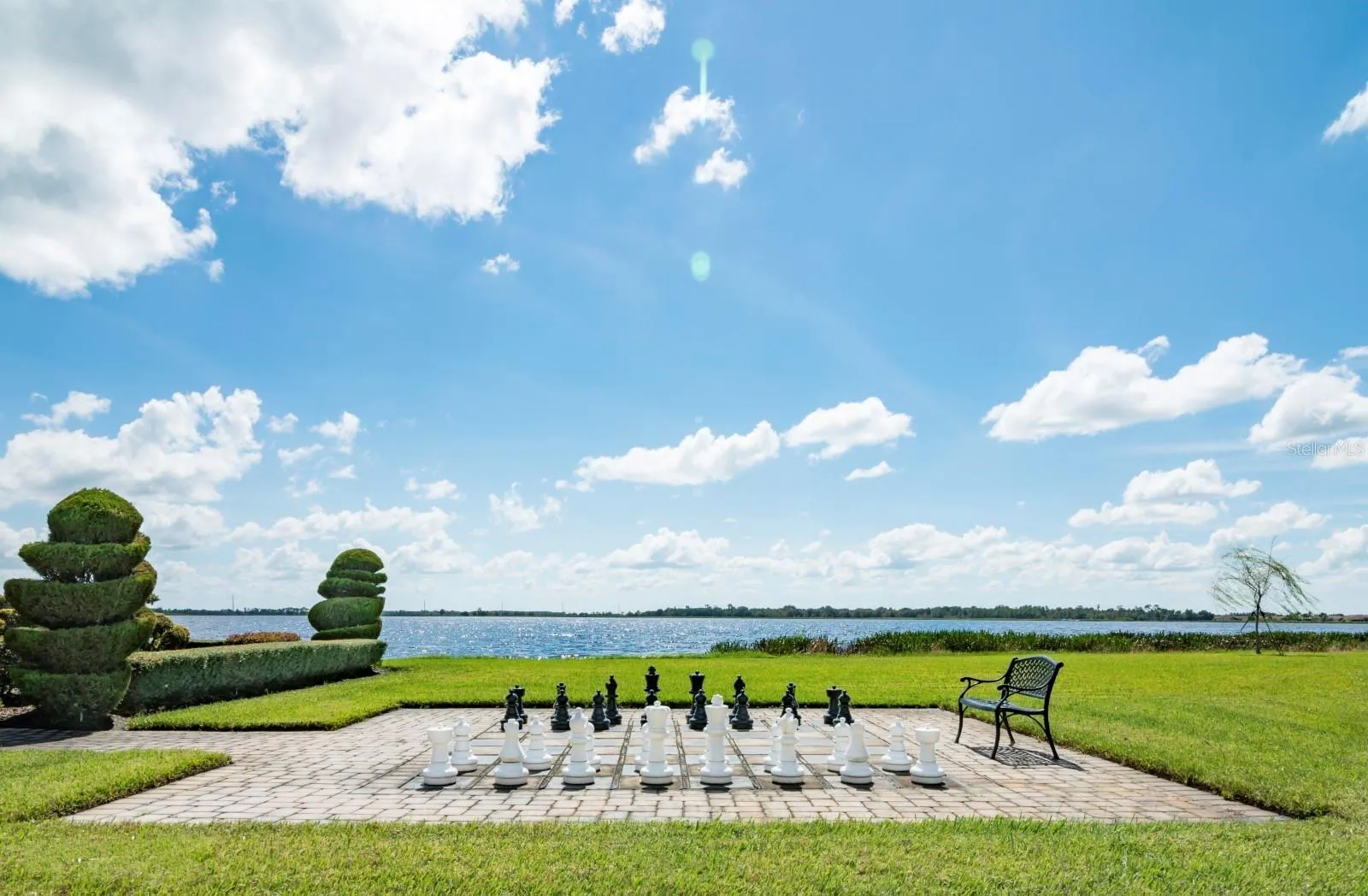 An oversized chess board and pieces are on the main clubhouse grounds.