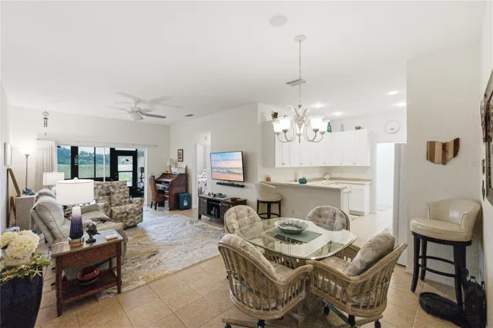 The central core includes the kitchen, dining, and living room. The double slider opens to the enclosed lanai.