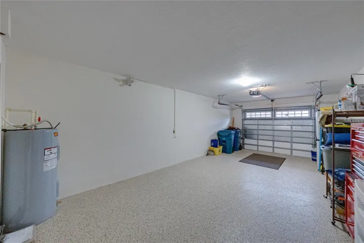 The attached garage has an opener and windows in the garage door.