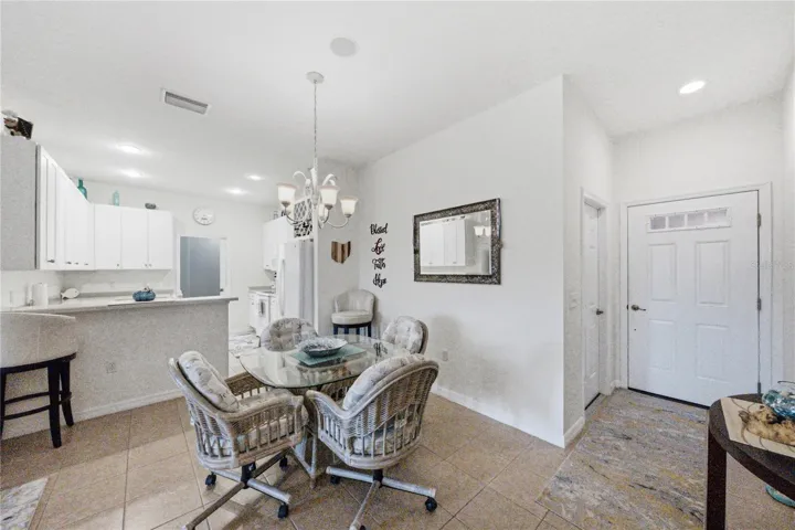 The dining area of the great room adjoins the foyer, kitchen and living room.
