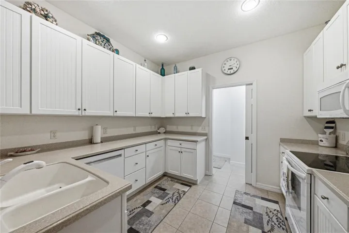 The kitchen has upgraded cabinets with 42" uppers, Corian countertops and over the cabinet lighting.