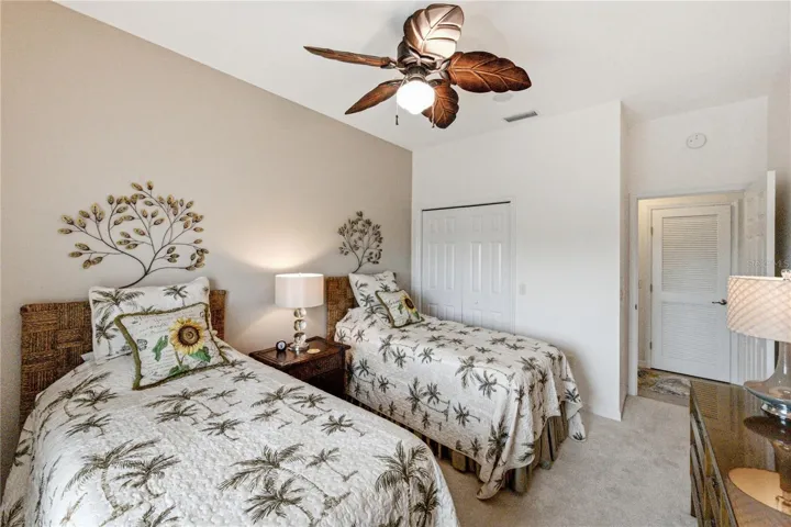 The guest bedroom has a designer ceiling fan with light, reach-in closet, and quality carpeting.