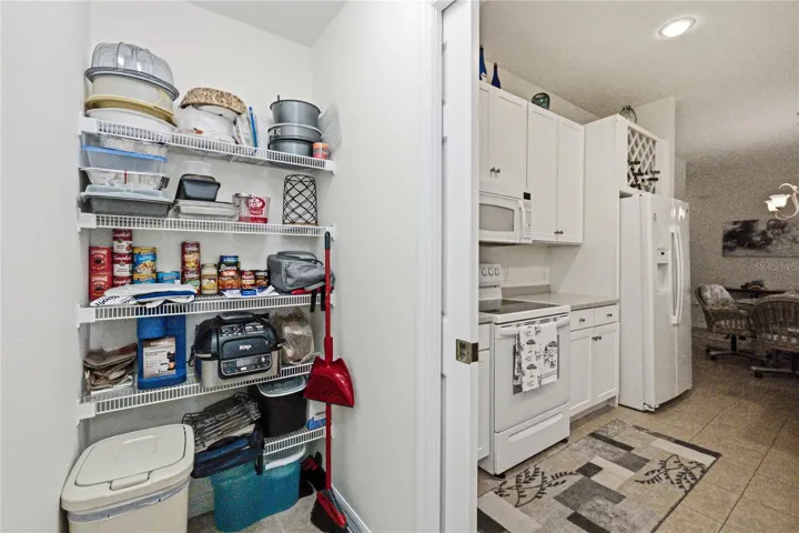The laundry room has storage and a pocket door.