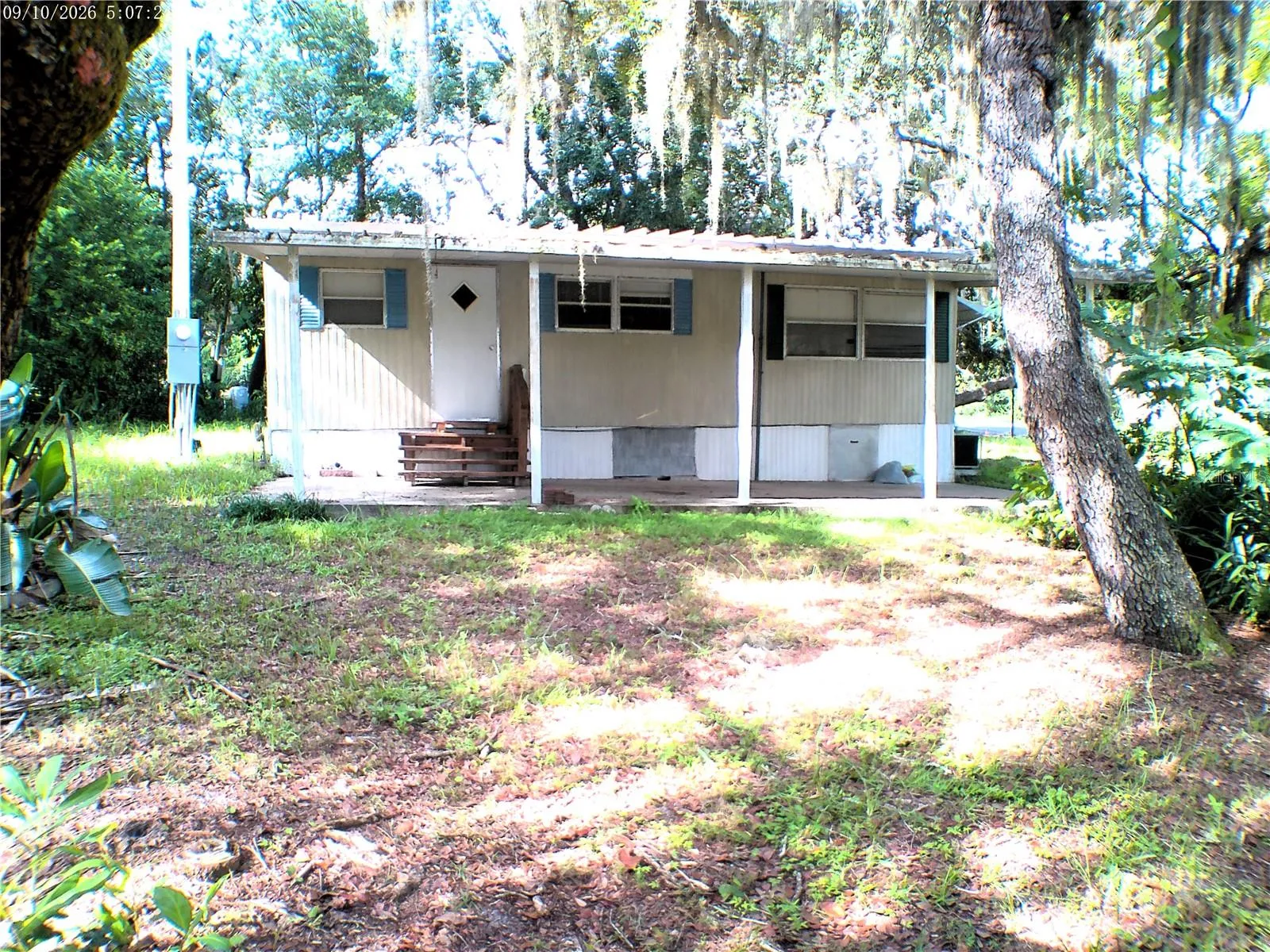 CARPORT LEFT SIDE OF HOME