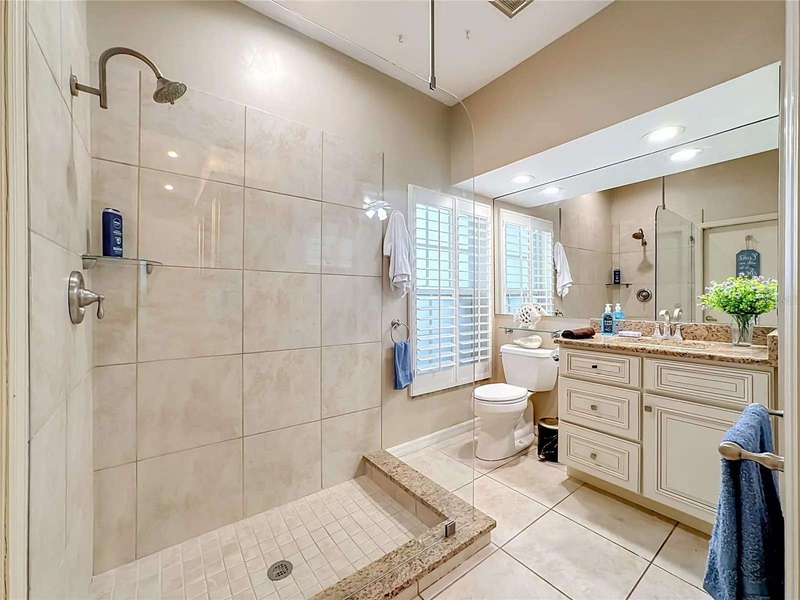Bathroom #2 Granite counterr top vanity, plantion window shades.