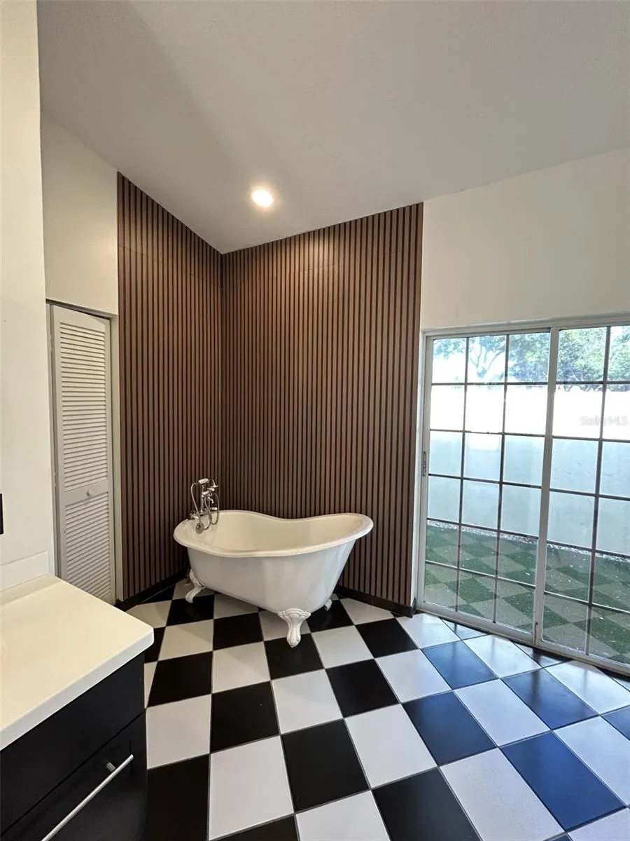 Rich wood paneling with a danity claw foot tub.
