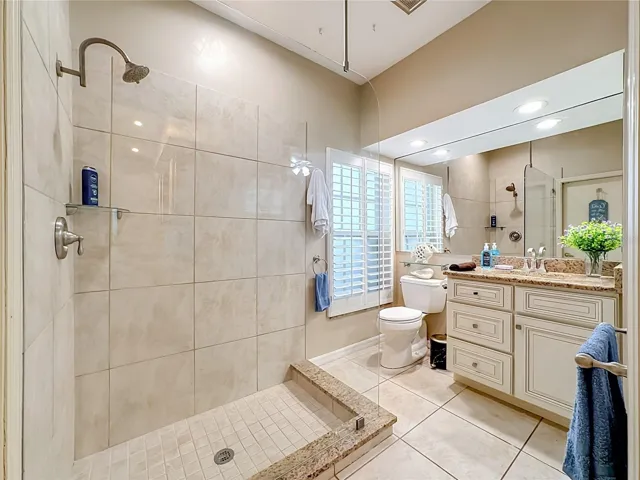 Bathroom #2 Granite counterr top vanity, plantion window shades.