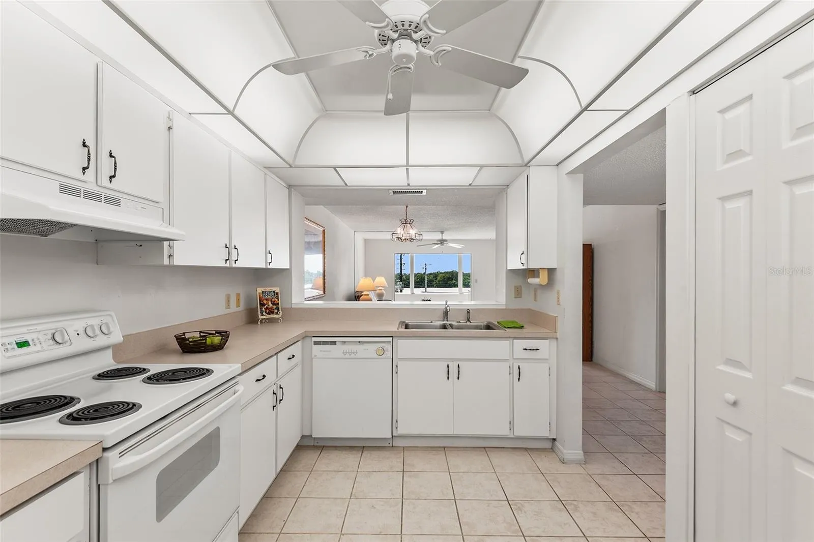 KITCHEN WITH PASS THRU TO DINING AREA. PANTRY CLOSET ON RIGHT.